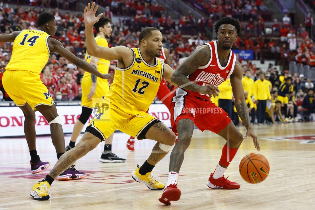 Jay Laprete Ohio State's Jamari Wheeler, right, looks for an opening as Michigan's DeVante Jones defends during the second half of an NCAA college basketball game, Sunday, March 6, 2022, in Columbus, Ohio. (AP Photo/Jay LaPrete)