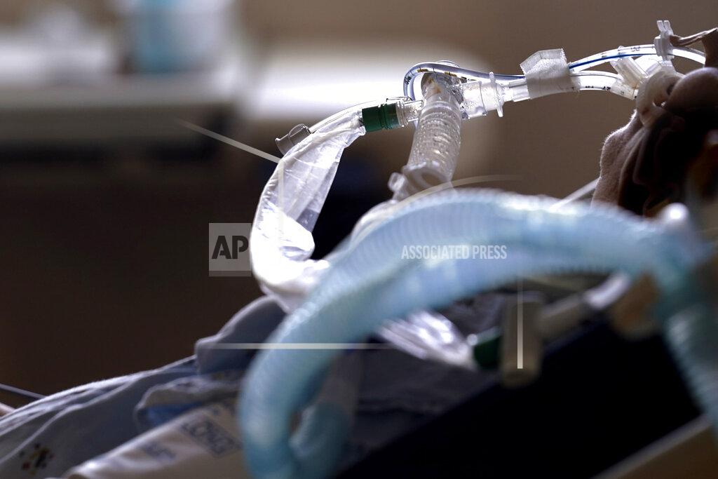 Gerald Herbert FILE - In this Aug. 17, 2021, file photo, patient with COVID-19 on breathing support lies in a bed in an intensive care unit at the Willis-Knighton Medical Center in Shreveport, La. The summer that was supposed to mark America’s independence from COVID-19 is instead drawing to a close with the U.S. more firmly under the tyranny of the virus, with deaths per day back up to where they were in March 2021. (AP Photo/Gerald Herbert, File)