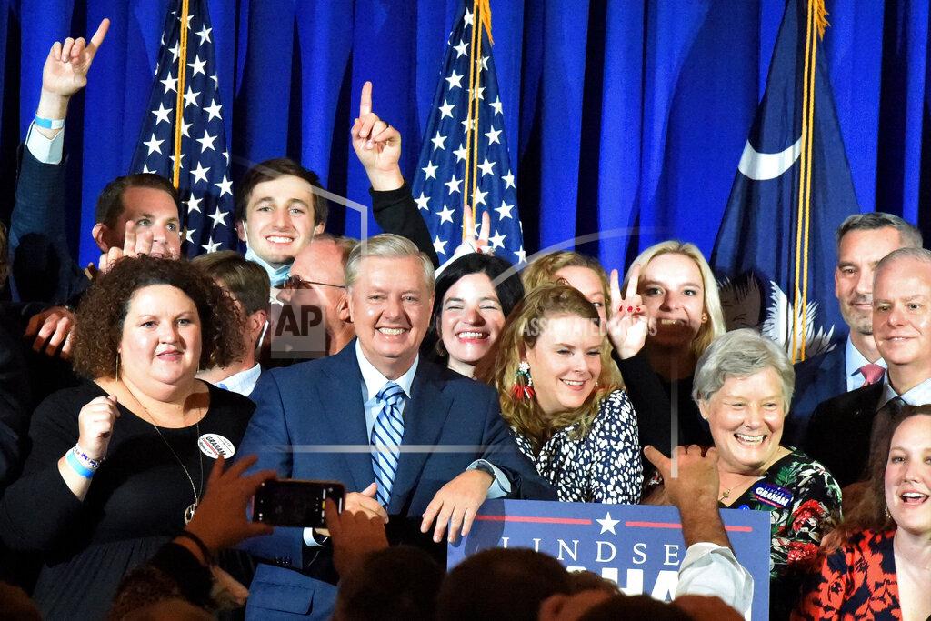 Meg Kinnard Supporters pose with U.S. Sen. Lindsey Graham, center, following his victory speech after winning another term in office on Tuesday, Nov. 3, 2020, in Columbia, S.C. (AP Photo/Meg Kinnard)