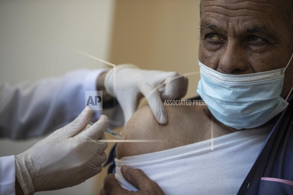 Khalil Hamra A Palestinian man receives a shot of the Russian-made Sputnik V coronavirus vaccine, at an UNRWA clinic in Gaza City, Wednesday, March 17, 2021. The Palestinian Authority says it will receive 62,000 coronavirus vaccine doses through a World Health Organization partnership designed to help poor countries. (AP Photo/Khalil Hamra)