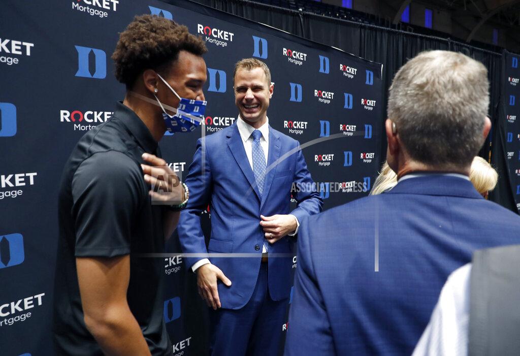 Jon Scheyer center, laughs while talking with Wendell Moore Jr. after an NCAA college basketball press conference at Cameron Indoor Stadium in Durham, N.C., Friday, June 4, 2021. Scheyer will spend the upcoming year in his role as associate head coach as coach Mike Krzyzewski chases one more championship in a Hall of Fame career. Then it’s up to the 33-year-old Scheyer to take over ahead of the 2022-23 season in the program’s first coaching change in more than four decades. (Ethan Hyman/The News & Observer via AP)