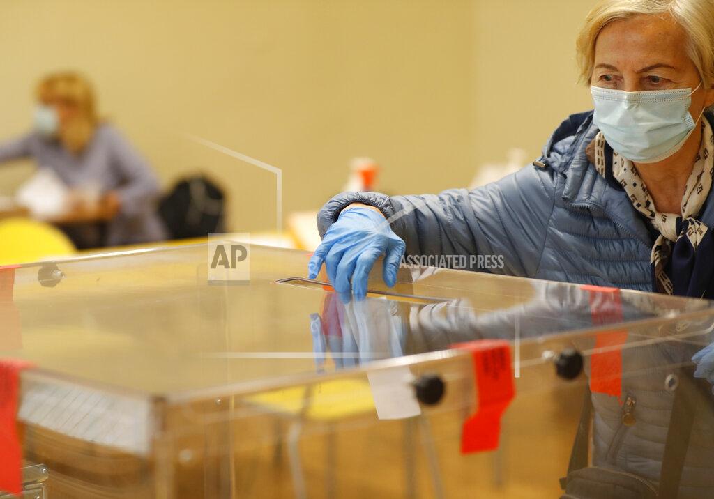 Petr David Josek A woman casts her vote during presidential runoff election in Krakow, Poland, Sunday, July 12, 2020. Voting started Sunday in Poland’s razor-blade-close presidential election runoff between the conservative incumbent Andrzej Duda and liberal, pro-European Union Warsaw Mayor Rafal Trzaskowski.(AP Photo/Petr David Josek)