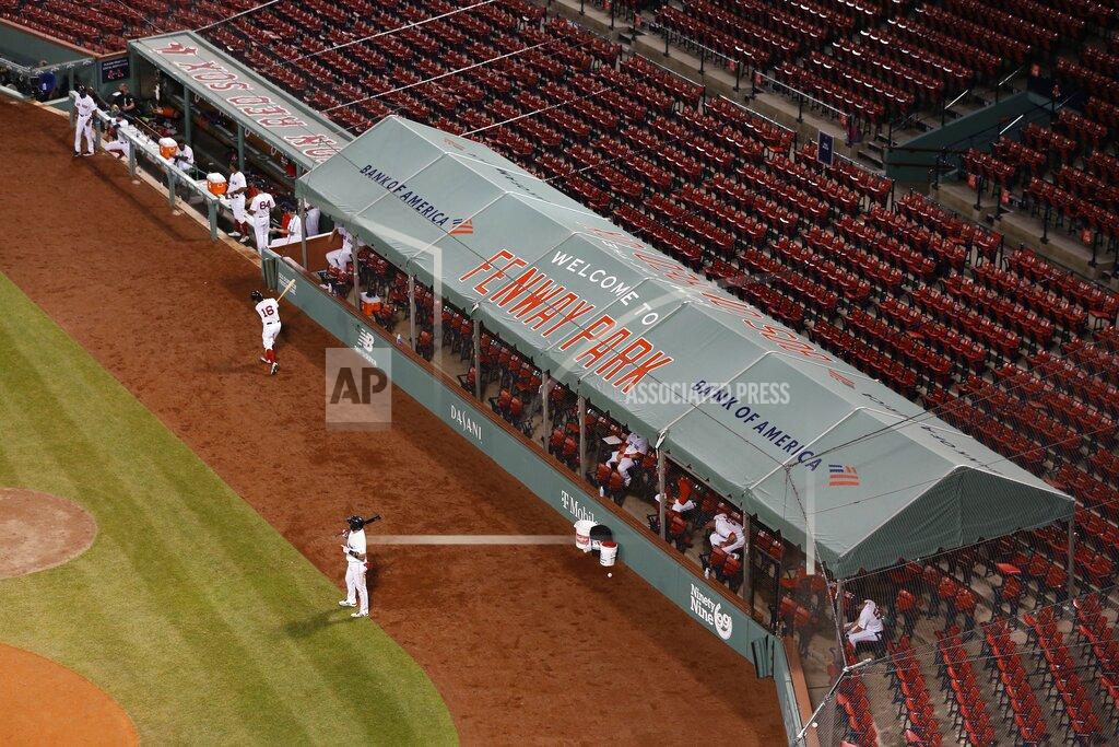 Michael Dwyer Boston Red Sox players spread out in an expanded dugout during the fifth inning of an opening day baseball game against the Baltimore Orioles at Fenway Park, Friday, July 24, 2020, in Boston. (AP Photo/Michael Dwyer)