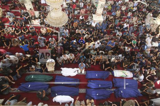 FILE - Mourners pray by the bodies of Salem Abu Quta family members, a Hamas fighter, during a funeral after they were killed in an Israeli strike on their house in Rafah refugee camp, southern Gaza Strip, Sunday, Oct. 8, 2023. As the fifth Israel-Hamas war rages, growing more deadly and devastating, international and local monitoring groups in besieged Gaza have been unable to keep up. (AP Photo/Hatem Ali, File)