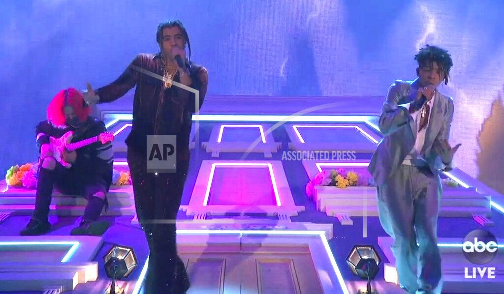 Uncredited In this screen shot provided by ABC on Sunday, Nov. 22, 2020, 24KGOLDN, left, and Iann Dior perform “Mood”at the American Music Awards at the Microsoft Theater in Los Angeles. (ABC via AP)