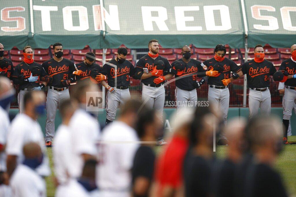 Michael Dwyer The Boston Red Sox and the Baltimore Orioles line up on the base lines during the national anthem before an opening day baseball game at Fenway Park, Friday, July 24, 2020, in Boston. (AP Photo/Michael Dwyer)