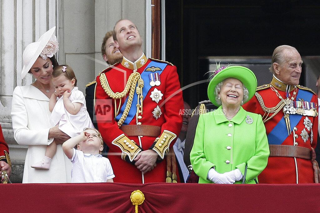 Tim Ireland FILE - Britain's Queen Elizabeth II wears a bright green outfit as she appears with Prince Philip, right, Prince William, center, his son Prince George, front, and Kate, Duchess of Cambridge holding Princess Charlotte, left, on the balcony during the Trooping The Colour parade at Buckingham Palace, in London, on June 11, 2016. (AP Photo/Tim Ireland, File)