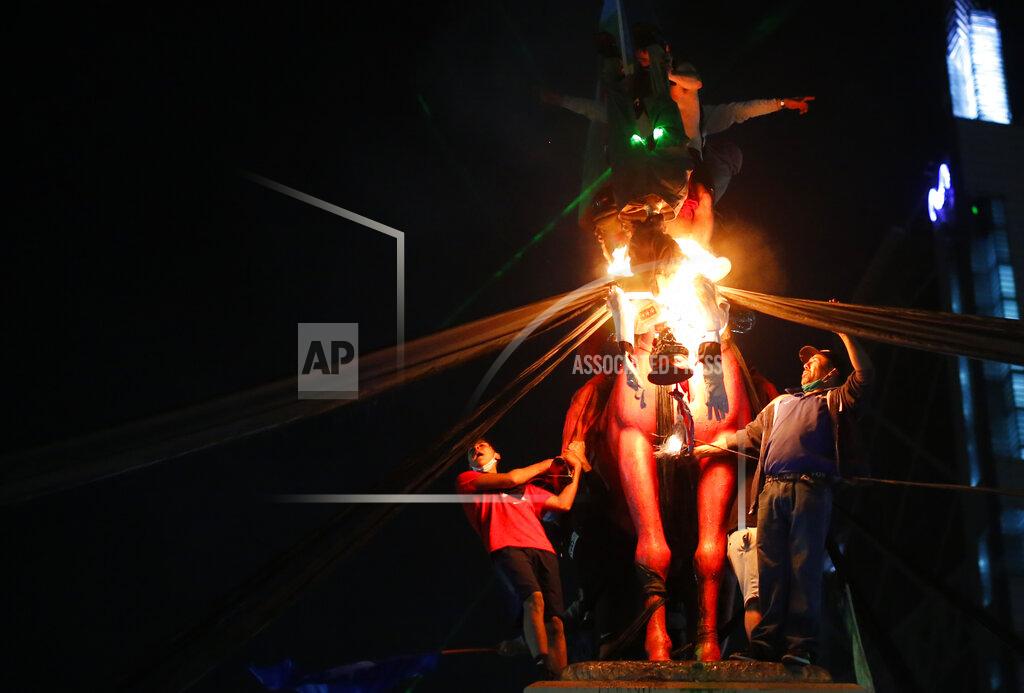 Luis Hidalgo Demonstrators burn a doll depicting Gen. Augusto Pinochet on the day Chileans voted in a referendum to decide whether the country should replace its 40-year-old constitution, written during the dictatorship of Gen. Augusto Pinochet, in Santiago, Sunday, Oct. 25, 2020. (AP Photo/Luis Hidalgo)