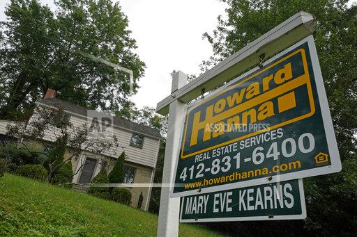 This is a home for sale in Mount Lebanon, Pa., on Tuesday, Sept. 21, 2021. U.S. mortgage rates were mixed this week, Thursday, Nov. 24. The average rate on the benchmark 30-year, fixed rate home loan was unchanged from last week at 3.1%; a year ago, it stood at 2.72%. (AP Photo/Gene J. Puskar)