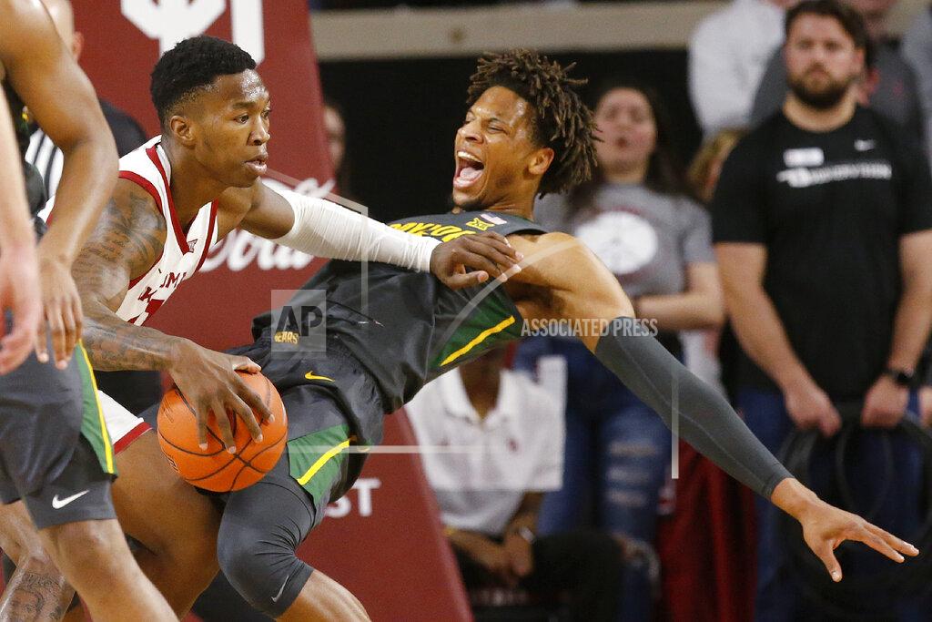 Sue Ogrocki Oklahoma forward Kristian Doolittle, left, drives against Baylor forward Freddie Gillespie during the first half of an NCAA college basketball game in Norman, Okla., Tuesday, Feb. 18, 2020. (AP Photo/Sue Ogrocki)