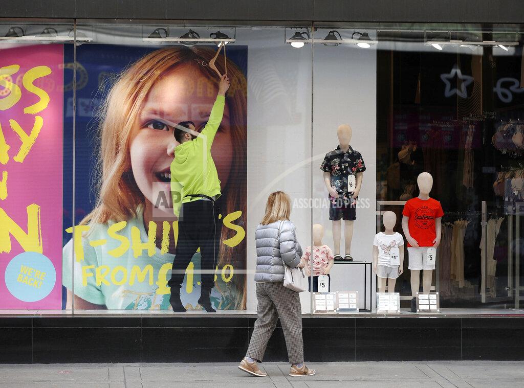 Yui Mok Final touches are made to a window display in a Primark store on Oxford Street, central London, Sunday April 11, 2021. Millions of people in Britain will get their first chance in months for haircuts, casual shopping and restaurant meals on Monday, as the government takes the next step on its lockdown-lifting roadmap. (Yui Mok/PA via AP)