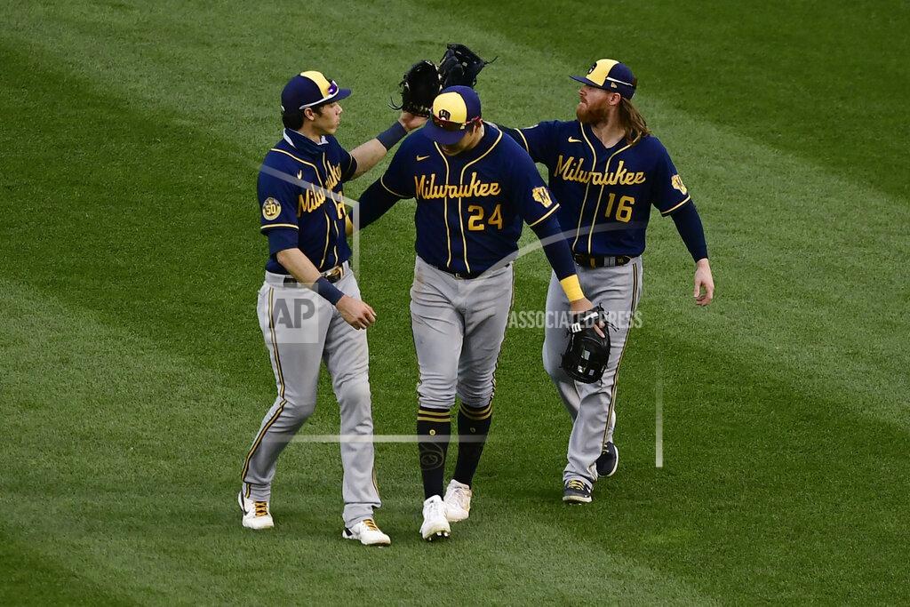 Paul Beaty Milwaukee Brewers outfielders Christian Yelich, Avisail Garcia and Ben Gamel, from left, celebrate after the Brewers defeated the Chicago Cubs 6-5 in 10 innings in a baseball game Saturday, Aug. 15, 2020, in Chicago. (AP Photo/Paul Beaty)