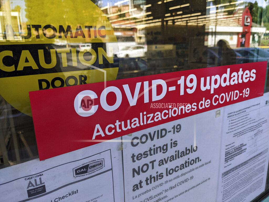 Damian Dovarganes A sign is posted "COVID-19 testing in NOT available at this location," on the doors of a CVS pharmacy in Los Angeles Wednesday, Feb. 3, 2021. California's rollout has been bumpy and chaotic, marked by differing county rules and too little vaccine. The Biden administration has pledged to ramp up delivery, and on Tuesday, Feb. 2, CVS pharmacies announced it would start inoculating people in some California stores next week.(AP Photo/Damian Dovarganes)