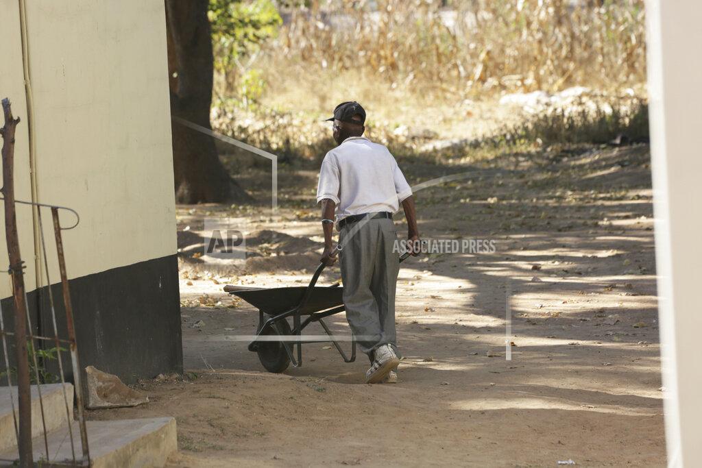Tsvangirayi Mukwazhi An elderly man pushes a wheelbarrow at the Society for the Destitute Aged care home in Harare's Highfield township, Zimbabwe, Saturday June, 26, 2021. The economic ravages of COVID-19 are forcing some families in Zimbabwe to abandon the age old tradition of taking care of the elderly. Zimbabwe's care homes have experienced a 60% increase in admissions since the outbreak of the pandemic in March last year. (AP Photo/Tsvangirayi Mukwazhi)
