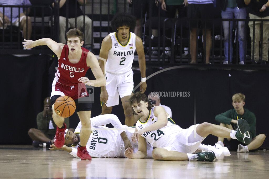 Rod Aydelotte Nicholls State guard Pierce Spencer (5) takes off after a loose ball as Baylor's Flo Thamba (0), Matthew Mayer (24), and Kendall Brown (2) watch in the first half of an NCAA college basketball game, Monday, Nov. 15, 2021, in Waco, Texas. (AP Photo/Rod Aydelotte)