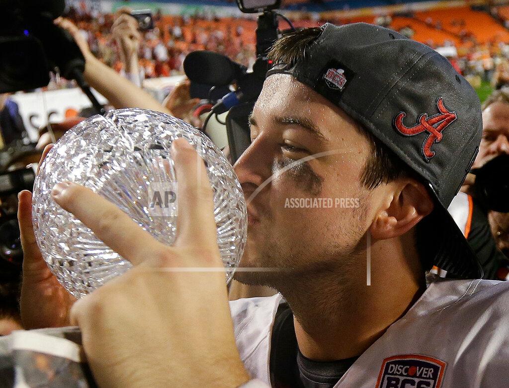 David J. Phillip FILE - In this Jan. 7, 2013, file photo, Alabama's AJ McCarron kissed The Coaches' Trophy after the BCS National Championship college football game against Notre Dame, in Miami. Alabama has claimed three of the decade's first six national titles. (AP Photo/David J. Phillip, File)