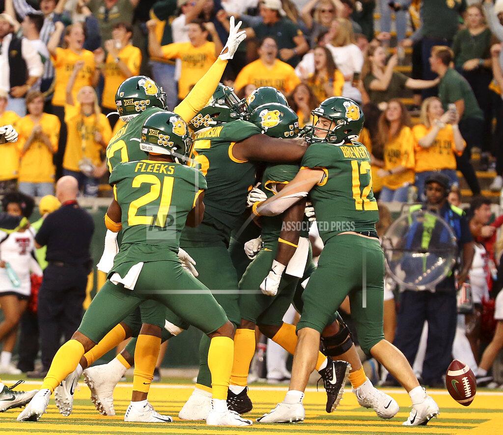 Jerry Larson Baylor quarterback Charlie Brewer (12), right celebrates a touchdown with his teammates against Texas Tech in the second overtime of a NCAA college football game in Waco, Tex.,Saturday, Oct. 12, 2019. Baylor won 33-30. (AP Photo/Jerry Larson)