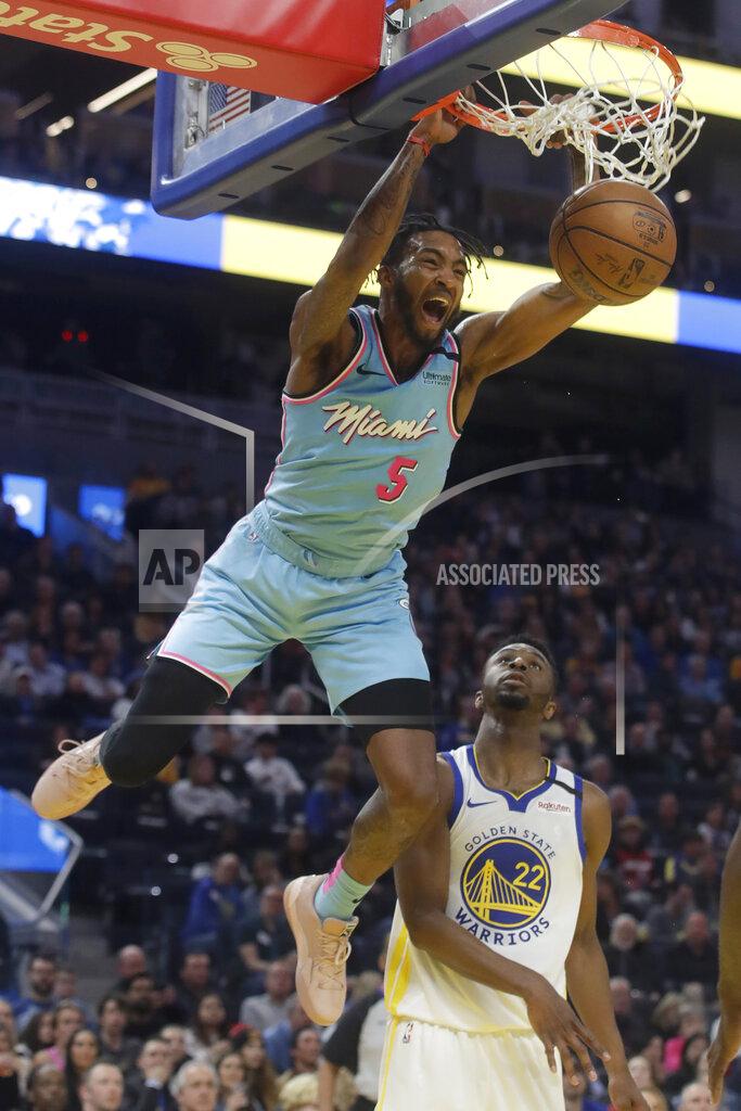 Jeff Chiu FILE - In this Feb. 10, 2020, file photo, Miami Heat forward Derrick Jones Jr. (5) dunks over Golden State Warriors guard Andrew Wiggins (22) during the first half of an NBA basketball game in San Francisco. A person with knowledge of the situation says Miami forward Derrick Jones Jr. has tested positive for the coronavirus. His result came in shortly after the Heat and other NBA teams began mandatory testing in preparation for next month’s resumption of the season. Jones still plans to play when the Heat get back on the floor at the Disney complex near Orlando next month. (AP Photo/Jeff Chiu, File)