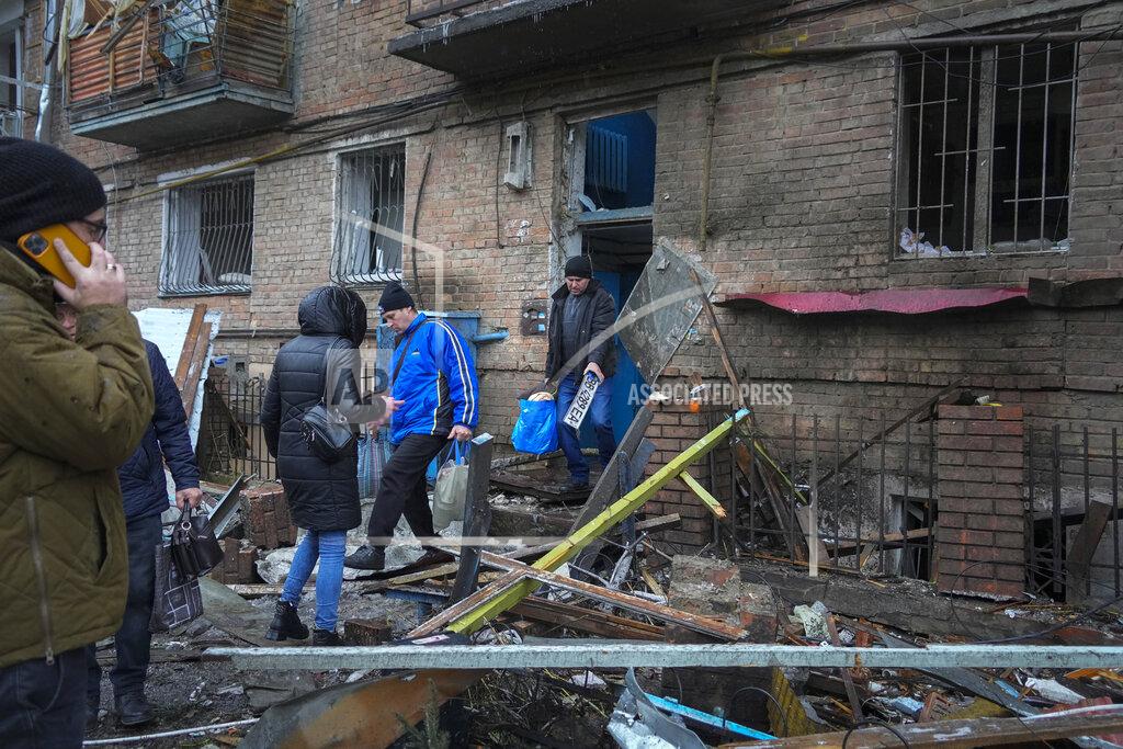 Efrem Lukatsky People gather their belongings from a damaged house after Russian shelling in the town of Vyshgorod outside the capital Kiev, Ukraine, Thursday, Nov. 24, 2022. About 70% of the Ukrainian capital was left without power on Thursday morning after Moscow unleashed yet another devastating missile barrage on Ukraine's energy infrastructure, Kyiv's mayor said. (AP Photo/Efrem Lukatsky)