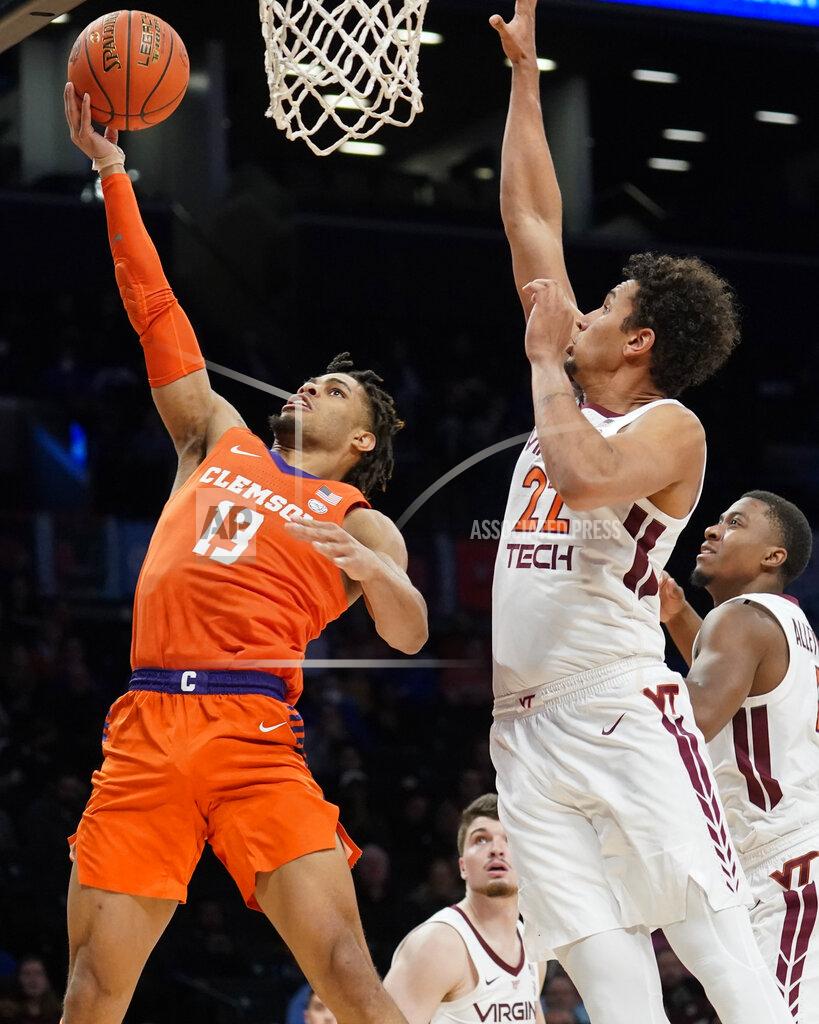 John Minchillo Clemson Tigers' David Collins (13) shoots against Virginia Tech's Keve Aluma (22) in the first half of an NCAA college basketball game during the Atlantic Coast Conference men's tournament, Wednesday, March 9, 2022, in New York. (AP Photo/John Minchillo)