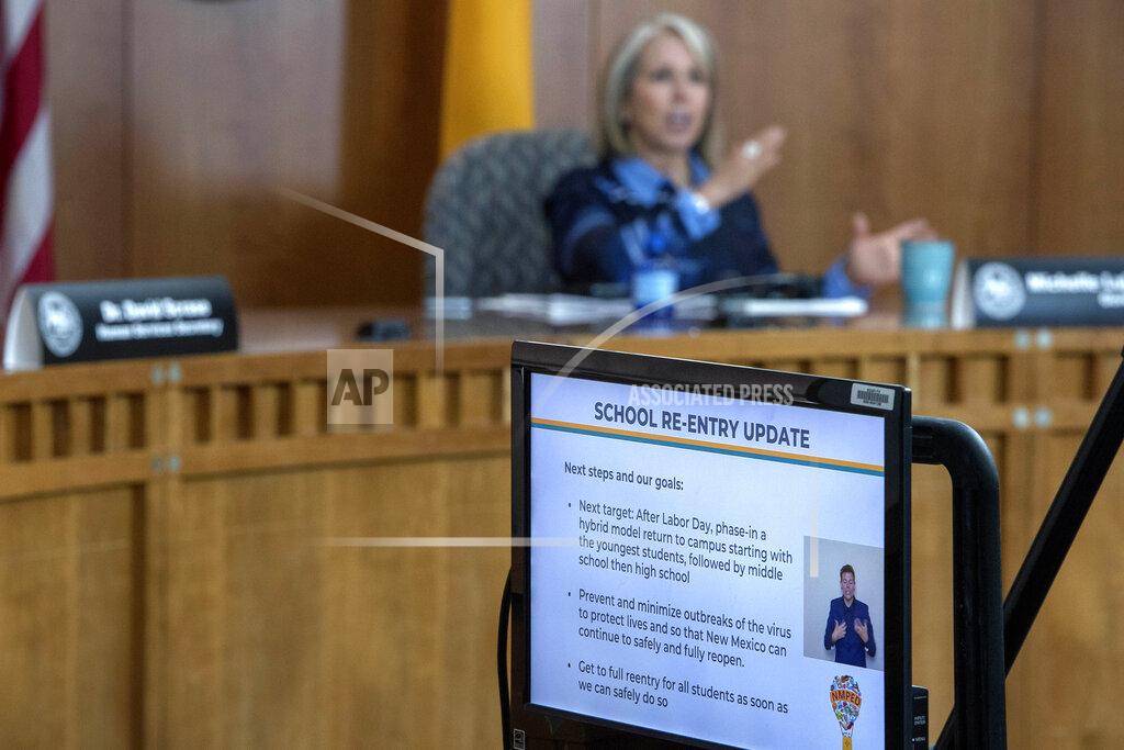 FILE - In this July 23, 2020, file photo, New Mexico Gov. Michelle Lujan Grisham talks about schools during an update on a COVID-19 broadcast from the state Capitol in Santa Fe, N.M. More school districts in New Mexico can bring students back into classrooms in early February, Gov. Michelle Lujan Grisham announced Tuesday, Jan. 26, 2021. The Democratic governor said she's allowing schools to open their doors to students of all ages, in a major pull-back of restrictions that were based on county-level COVID-19 case rates and hospital capacity. (Eddie Moore/The Albuquerque Journal via AP, File)