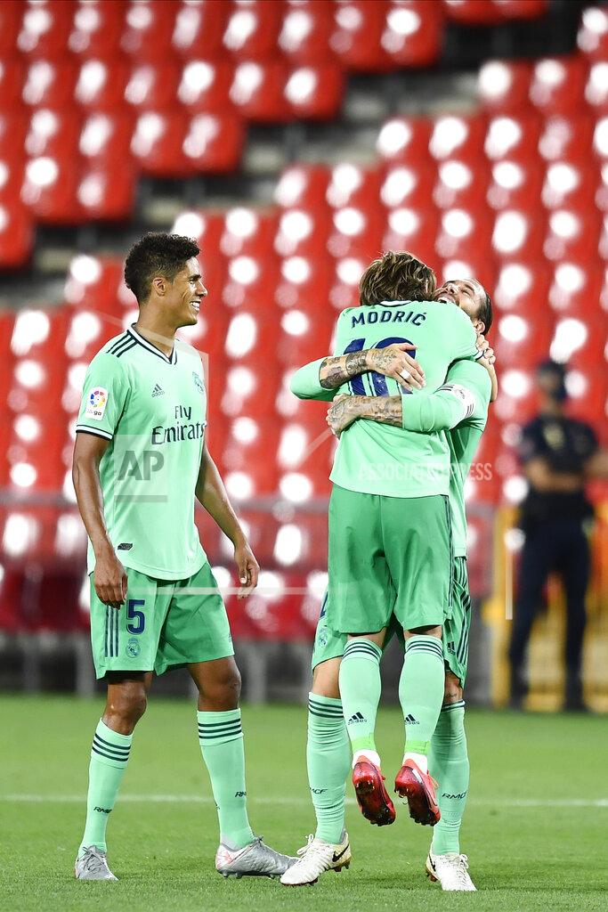 Jose Breton Real Madrid's Sergio Ramos, second right, celebrates his team victory over Granada with his teammate Real Madrid's Luka Modric during the Spanish La Liga soccer match between Granada and Real Madrid at the Los Carmenes stadium in Granada, Spain, Monday, July 13, 2020. (AP Photo/Jose Breton)