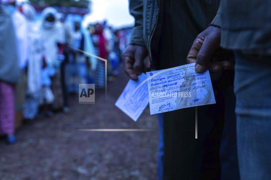 Mulugeta Ayene Ethiopians line up to cast vote in the general election in his home town of Beshasha, in the Oromia region of Ethiopia, Monday, June 21, 2021. Ethiopians are voting in a landmark election that is the centerpiece of a reform drive by Prime Minister Abiy Ahmed but is overshadowed by the situation in the country's war-hit Tigray region. (AP Photo/Mulugeta Ayene).