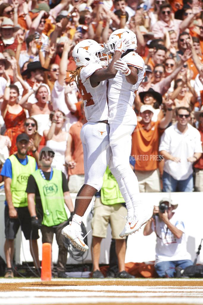 Cooper Neill Texas wide receiver Lil'Jordan Humphrey, left, celebrates after scoring a touchdown on a 15-yard reception with teammate John Burt (1) against Oklahoma during the second half of an NCAA college football game at the Cotton Bowl, Saturday, Oct. 6, 2018, in Dallas. (AP Photo/Cooper Neill)