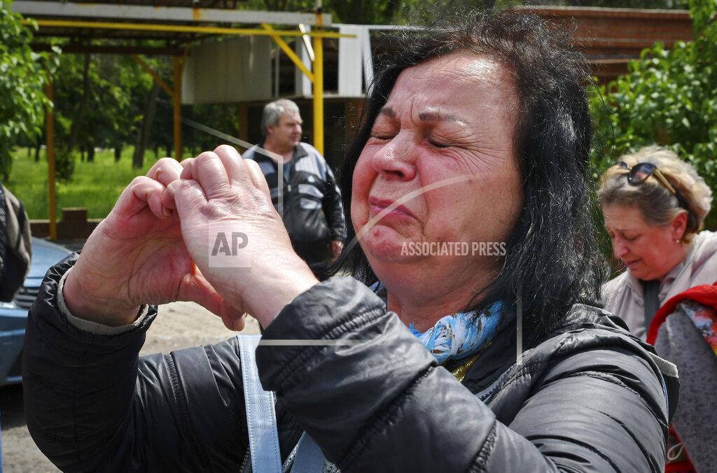 Andriy Andriyenko A woman reacts during an evacuation of civilians in Soledar, Donetsk region, Ukraine, Tuesday, May 24, 2022. (AP Photo/Andriy Andriyenko)