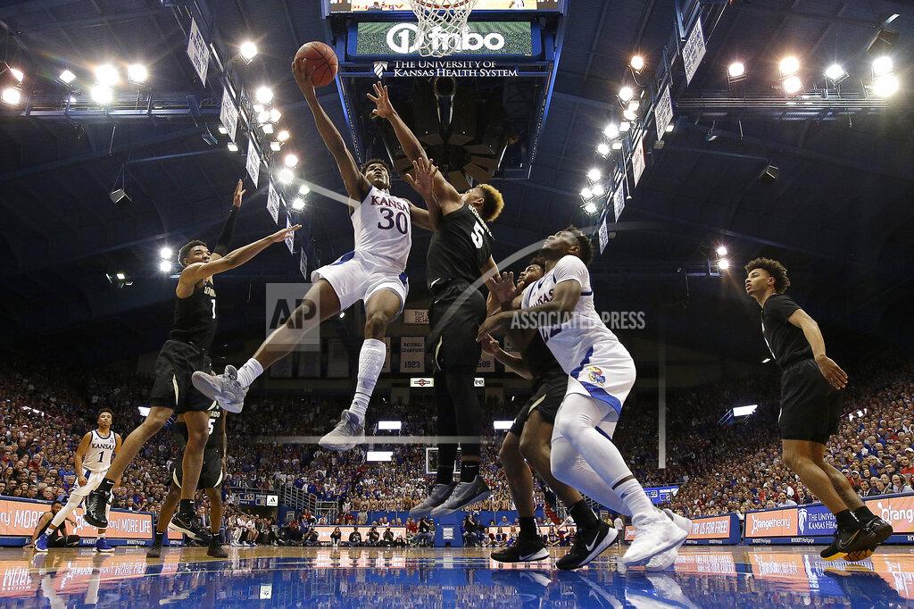 Charlie Riedel Kansas' Ochai Agbaji (30) gets past D'Shawn Schwartz (5) to shoot during the first half of an NCAA college basketball game Saturday, Dec. 7, 2019, in Lawrence, Kan. Kansas won 72-58. (AP Photo/Charlie Riedel)