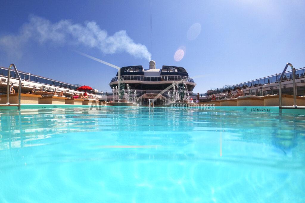 Andrew Medichini Passengers enjoy the sun by a swimming pool on board the MSC Grandiosa cruise ship in Civitavecchia, near Rome, Wednesday, March 31, 2021. MSC Grandiosa, the world's only cruise ship to be operating at the moment, left from Genoa on March 30 and stopped in Civitavecchia near Rome to pick up more passengers and then sail toward Naples, Cagliari, and Malta to be back in Genoa on April 6. For most of the winter, the MSC Grandiosa has been a lonely flag-bearer of the global cruise industry stalled by the pandemic, plying the Mediterranean Sea with seven-night cruises along Italy’s western coast, its major islands and a stop in Malta. (AP Photo/Andrew Medichini)