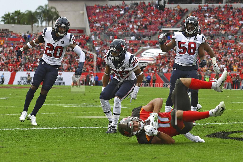 Jason Behnken Tampa Bay Buccaneers wide receiver Justin Watson (17) scores on a 8-yard touchdown reception after getting by Houston Texans strong safety Justin Reid (20), cornerback Vernon Hargreaves III (28) and linebacker Peter Kalambayi (58) during the first half of an NFL football game Saturday, Dec. 21, 2019, in Tampa, Fla. (AP Photo/Jason Behnken)