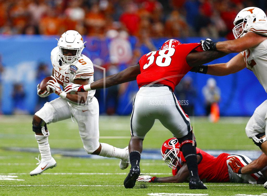 Butch Dill Texas running back Tre Watson (5) carries against Georgia linebacker Azeez Ojulari (38) during the first half of the Sugar Bowl NCAA college football game in New Orleans, Tuesday, Jan. 1, 2019. (AP Photo/Butch Dill)