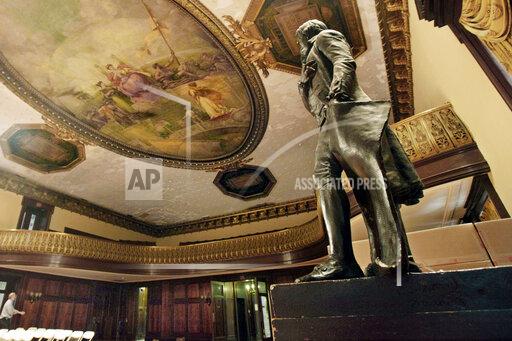 FILE - In this July 14, 2010, file photo, a statue of Thomas Jefferson, right, stands in New York's City Hall Council Chamber. The 1833 statue will be taken out of New York's City Hall in the coming days and sent to the New-York Historical Society as a long-term loan, capping longstanding efforts to remove the founding father's likeness because he owned slaves. (AP Photo/Richard Drew, File)