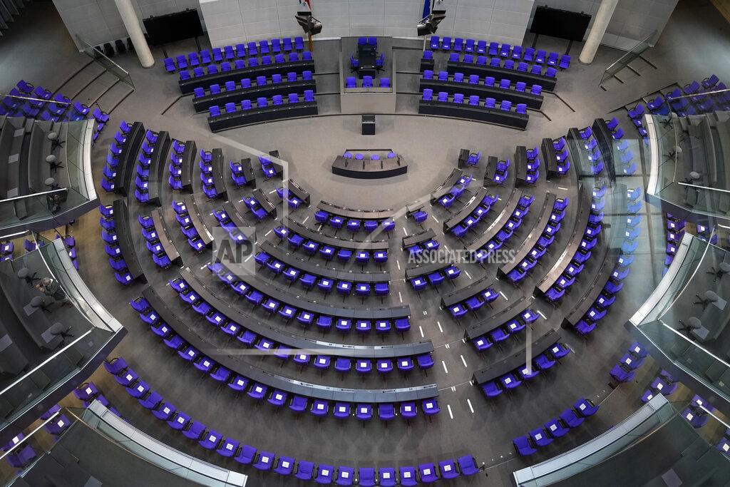Markus Schreiber A general view inside the plenary hall of the German parliament Bundestag at the Reichstag Building in Berlin, Germany, Thursday, Sept. 16, 2021. German voters elect a new parliament on Sunday, Sept. 26, 2021, a vote that will determine who succeeds Chancellor Angela Merkel after her 16 years in power. (AP Photo/Markus Schreiber)