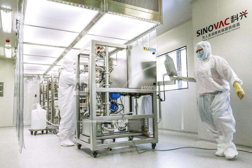 Zhang Yuwei FILE - In this July 15, 2020 photo released by China's Xinhua News Agency, Sinovac staff members work in a purification area to be used in production of COVID-19 vaccines in Beijing. Sinovac and Sinopharm both rely on a traditional technology called an inactivated virus vaccine, based on cultivating batches of the virus and then killing it. (Zhang Yuwei/Xinhua via AP)