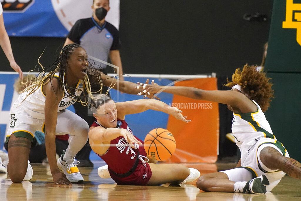 Lm Otero South Dakota center Hannah Sjerven (34) passes the ball from the floor against Baylor center Queen Egbo, left, and forward NaLyssa Smith (1) during the second half of a college basketball game in the second round of the NCAA tournament in Waco, Texas, Sunday, March 20, 2022. (AP Photo/LM Otero)