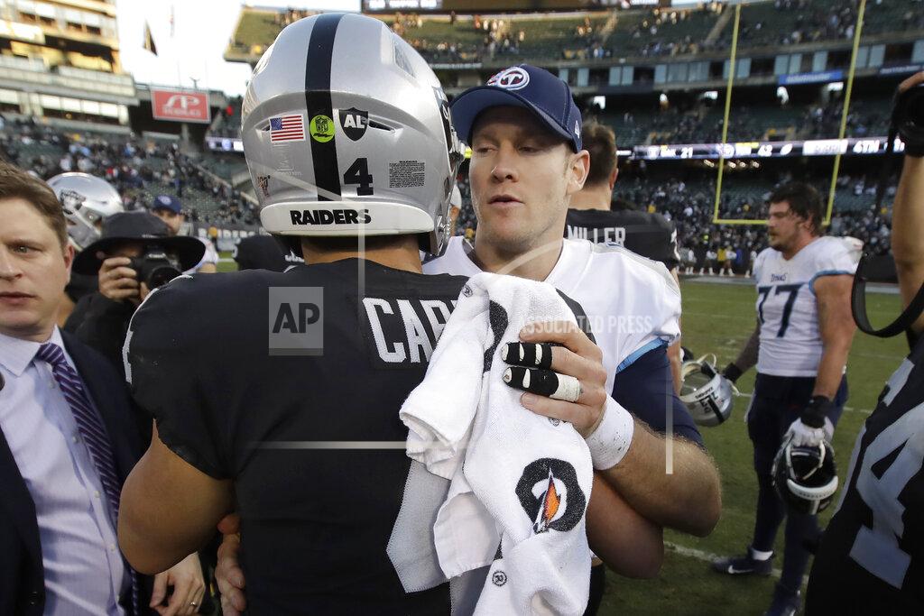 Ben Margot Tennessee Titans quarterback Ryan Tannehill, facing, greets Oakland Raiders quarterback Derek Carr after an NFL football game in Oakland, Calif., Sunday, Dec. 8, 2019. (AP Photo/Ben Margot)