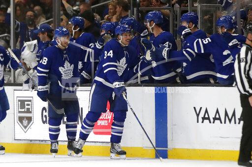 Toronto Maple Leafs center Auston Matthews (34) celebrates with teammates after scoring against the Los Angeles Kings during the second period of an NHL hockey game in Los Angeles, Wednesday, Nov. 24, 2021. (AP Photo/Alex Gallardo)