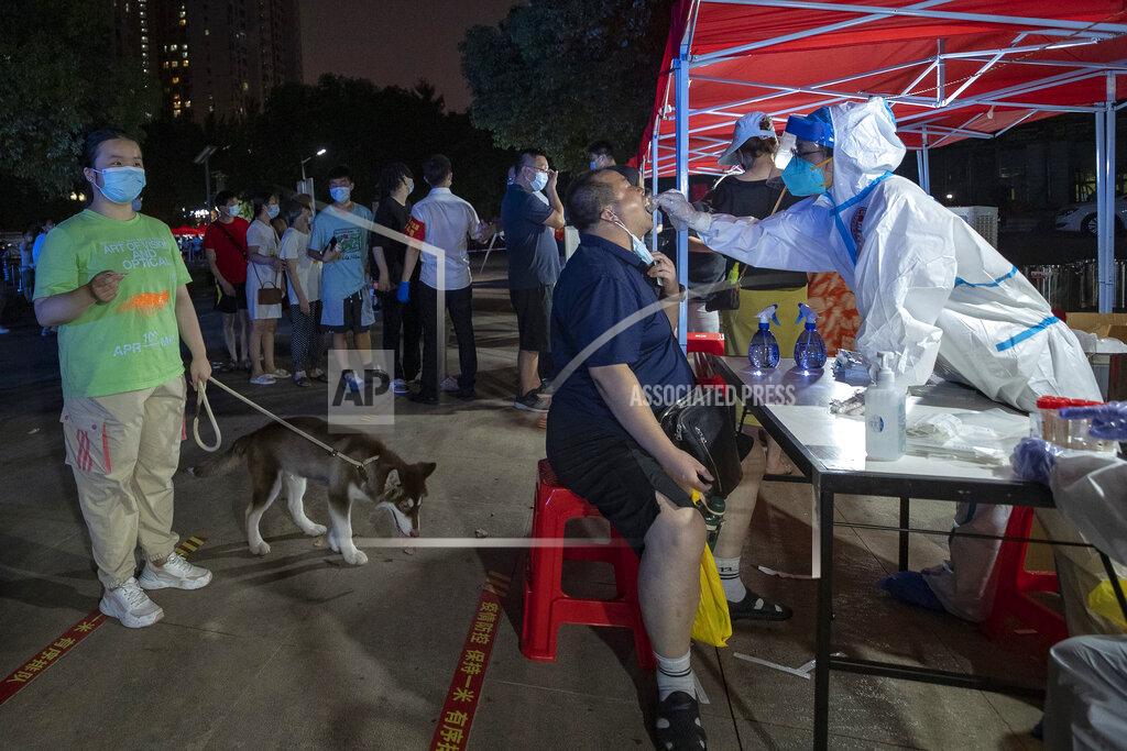 Uncredited Residents line up for Covid-19 tests in Wuhan in central China's Hubei province Tuesday, Aug. 3, 2021. China's worst coronavirus outbreak since the start of the pandemic a year and a half ago escalated Wednesday with dozens more cases around the country, the sealing-off of one city and the punishment of its local leaders. (Chinatopix Via AP)