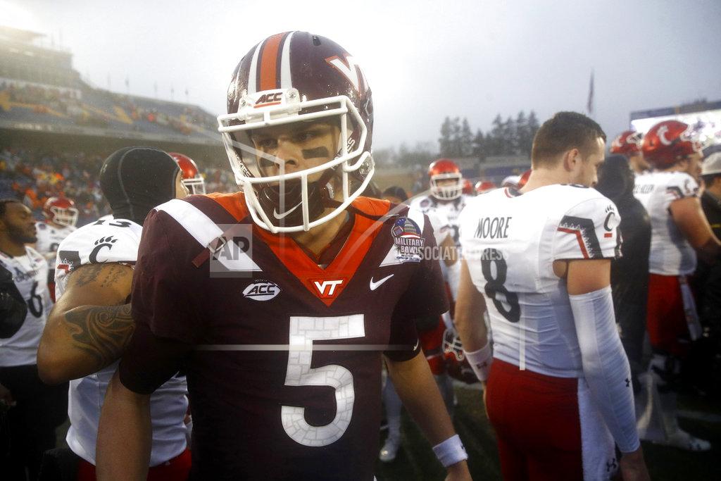 Patrick Semansky Virginia Tech quarterback Ryan Willis (5) walks off the field after speaking with Cincinnati quarterback Hayden Moore (8) in the second half of the Military Bowl NCAA college football game, Monday, Dec. 31, 2018, in Annapolis, Md. Cincinnati won 35-31. (AP Photo/Patrick Semansky)
