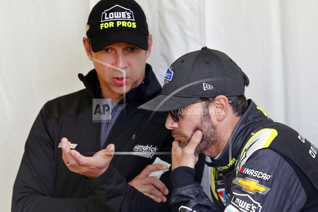 Steve Helber FILE - In this Friday, April 20, 2018, file photo, Jimmie Johnson, right, listens to crew chief Chad Knaus, as they wait for their car to get through inspection prior to qualifying for the NASCAR Cup Series auto race at Richmond Raceway in Richmond, Va. Johnson is retiring from full-time NASCAR competition in Sunday's season finale at Phoenix Raceway, leaving the sport as a seven-time champion ranked sixth on the all-time wins list with 83 career victories. (AP Photo/Steve Helber, FIle)