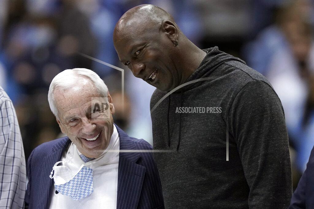 Gerry Broome Retired North Carolina coach Roy Williams, left, and former player Michael Jordan speak while being recognized with the 1982 team during a break in the second half of an NCAA college basketball game between North Carolina and North Carolina State in Chapel Hill, N.C., Saturday, Jan. 29, 2022. (AP Photo/Gerry Broome)