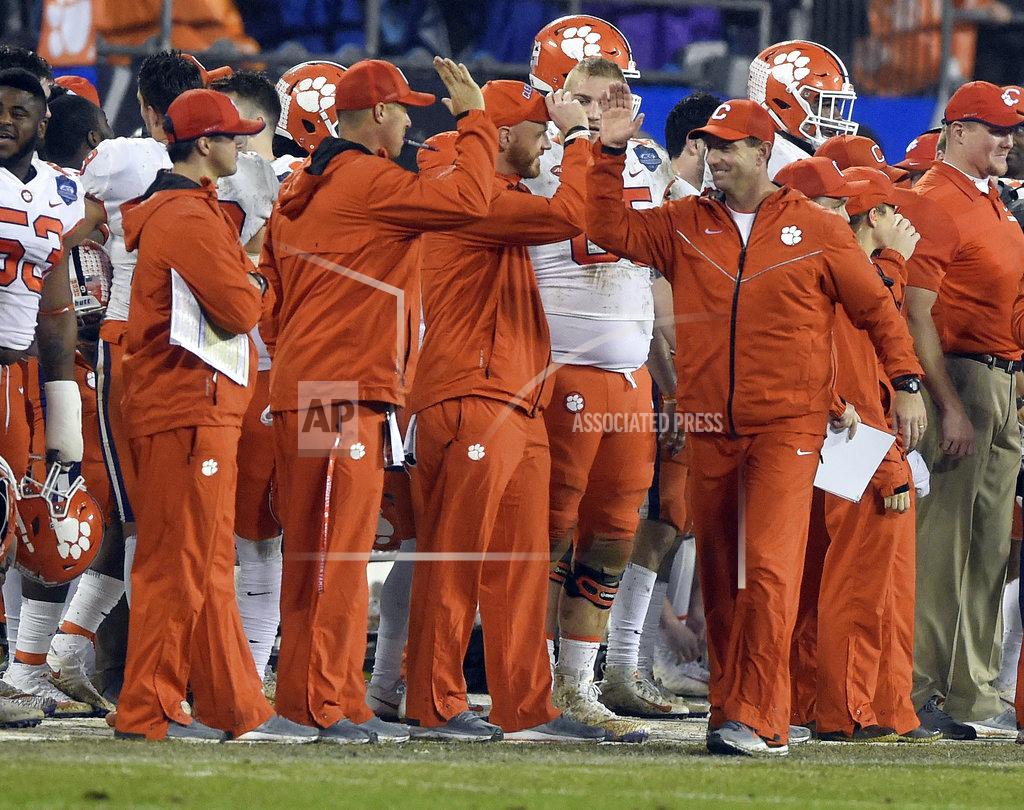 Mike Mccarn Clemson head coach Dabo Swinney, right, congratulates his coaching staff in the closing seconds of the second half of the Atlantic Coast Conference championship NCAA college football game against Pittsburgh in Charlotte, N.C., Saturday, Dec. 1, 2018. (AP Photo/Mike McCarn)