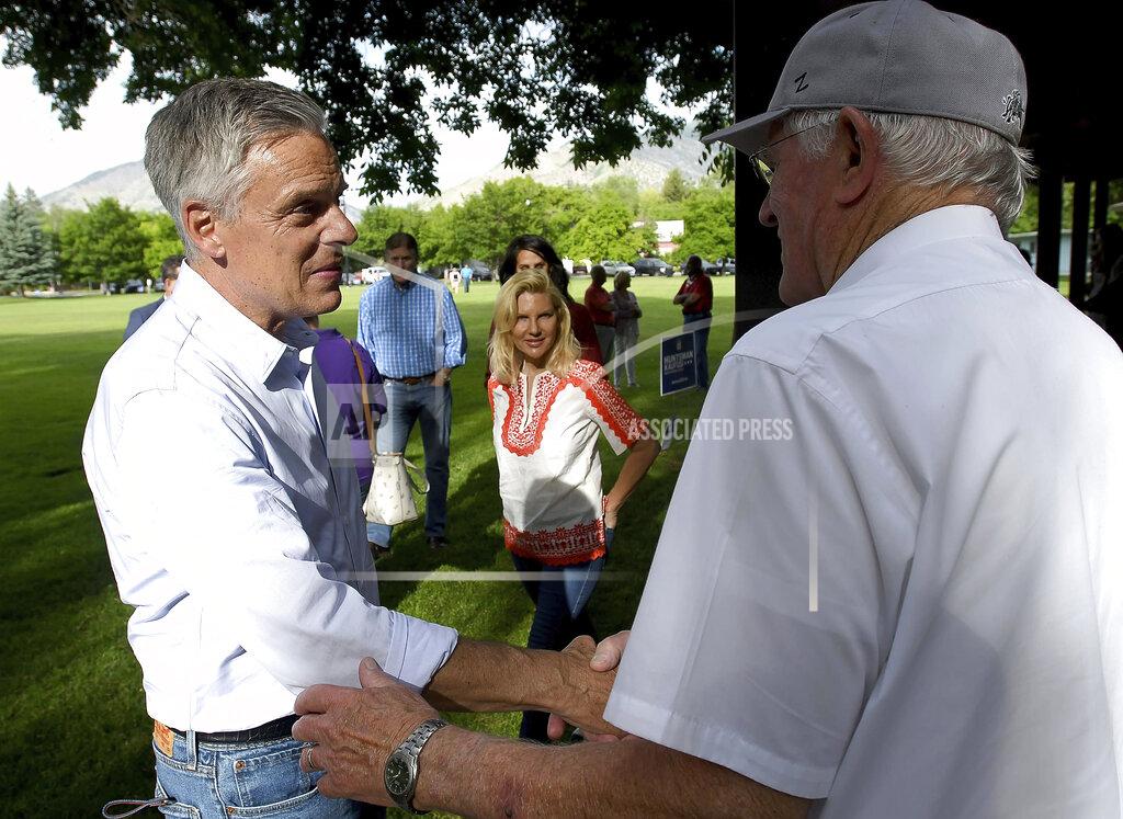 Utah gubernatorial candidate Jon Huntsman Jr., left, shakes hands with people during a campaign stop Thursday, June 4, 2020, in Logan, Utah. (Eli Lucero/Herald Journal via AP)