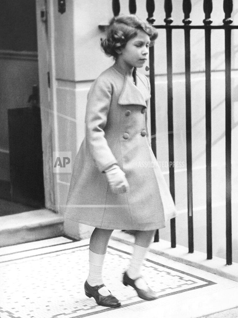 Uncredited FILE - Princess Elizabeth leaves a dentist appointment in the West End of London in October 1934. As a young princess and younger queen, her fashion choices have included nods to trends and a solid commitment to sensible dressing. (AP Photo, File)