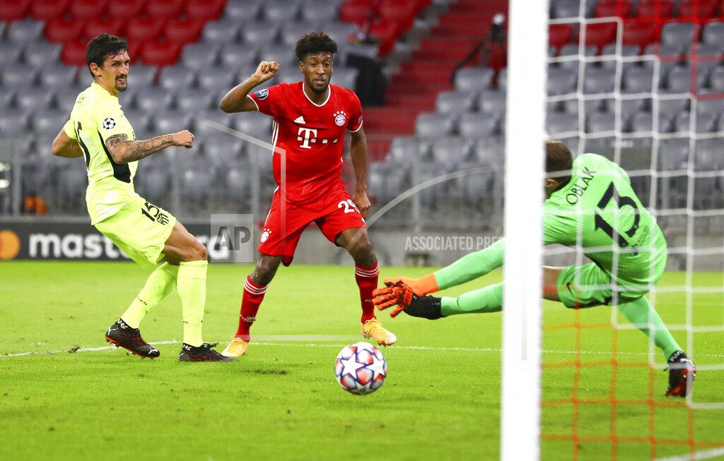 Matthias Schrader Bayern Munich's Kingsley Coman, centre, kicks the ball past Atletico Madrid's Stefan Savic, left, and goalkeeper Jan Oblak to score his team's first goal during the Champions League Group A soccer match between Bayern Munich and Atletico Madrid at the Allianz Arena in Munich, Germany, Wednesday, Oct. 21, 2020. (AP Photo/Matthias Schrader,Pool)