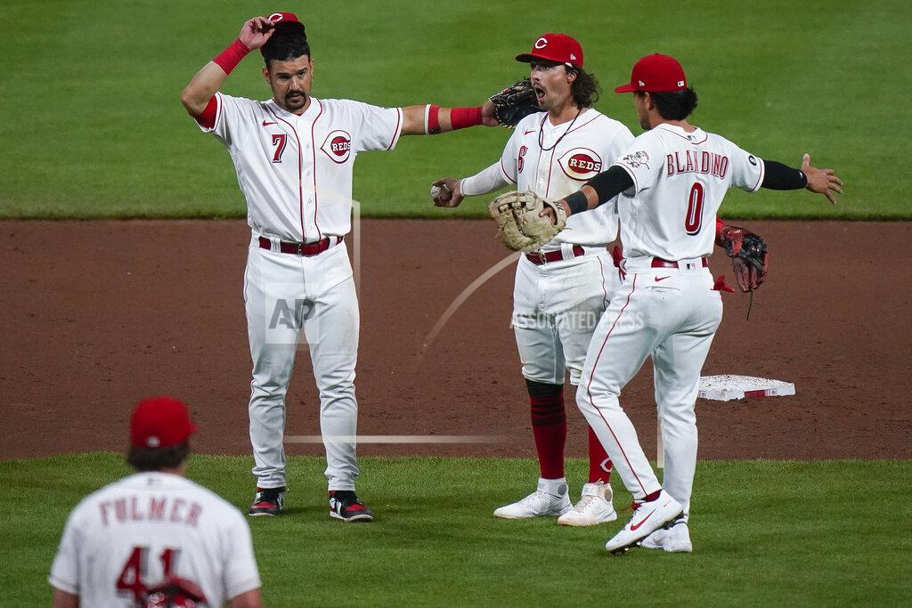 Bryan Woolston Cincinnati Reds' Jonathan India, center, celebrates with teammates Alex Blandino, right, and Eugenio Suarez, left, after defeating the Pittsburgh Pirates at Great American Ball Park in Cincinnati, Tuesday, April 6, 2021. (AP Photo/Bryan Woolston)