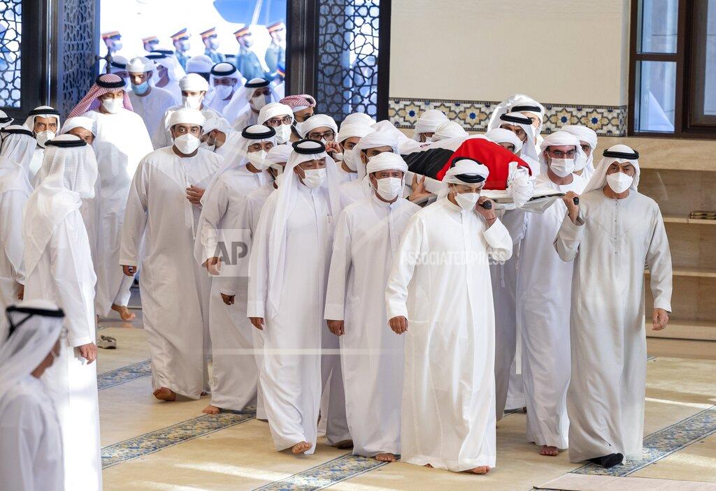 Abdulla Al Neyadi This photo made available by the Ministry of Presidential Affairs, shows UAE Crown Prince Sheikh Mohamed bin Zayed Al Nahyan, ruler of Abu Dhabi, front right, and Sheikh Mansour bin Zayed Al Nahyan, UAE Deputy Prime Minister and Minister of Presidential Affairs, front left, carry the body of Sheikh Khalifa bin Zayed Al Nahyan, president of the United Arab Emirates, with other members of royal family at Sheikh Sultan bin Zayed The First mosque, in Abu Dhabi, Friday, May 13, 2022. (Abdulla Al Neyadi/Ministry of Presidential Affairs via AP)