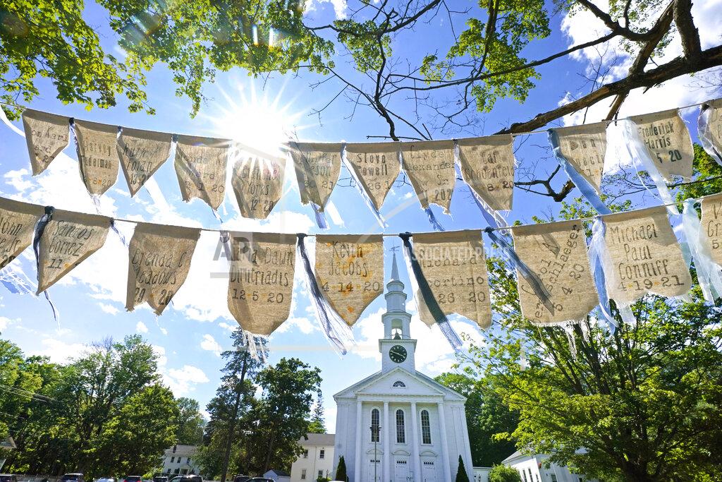 Elise Amendola Flags with names of people who have died from COVID-19 are displayed outside the First Congressional Church, Thursday, June 17, 2021, in Holliston, Mass. The flags are part of the COVID Art and Remembrance project spearheaded by Jaclyn Winer, whose father, Keith Jacobs, died in April 2020 from the coronavirus. (AP Photo/Elise Amendola)
